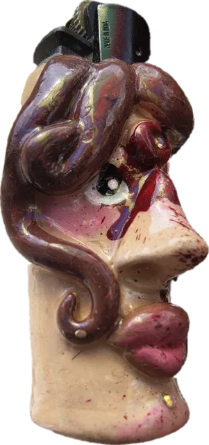Sculpted clay lighter case: wavy-haired face with a red tear